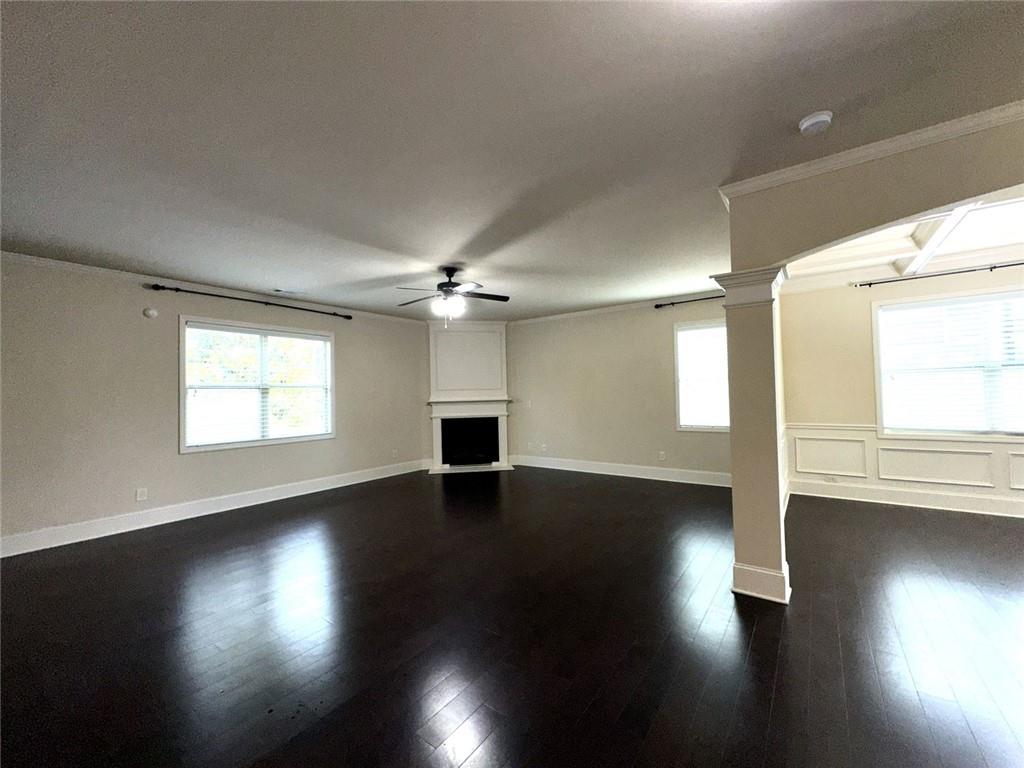 1365 Delo Lane Cumming, GA 30041 - Photo 7 of 43 a view of empty room with wooden floor and fan