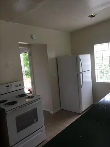 a view of a kitchen with a stove top oven