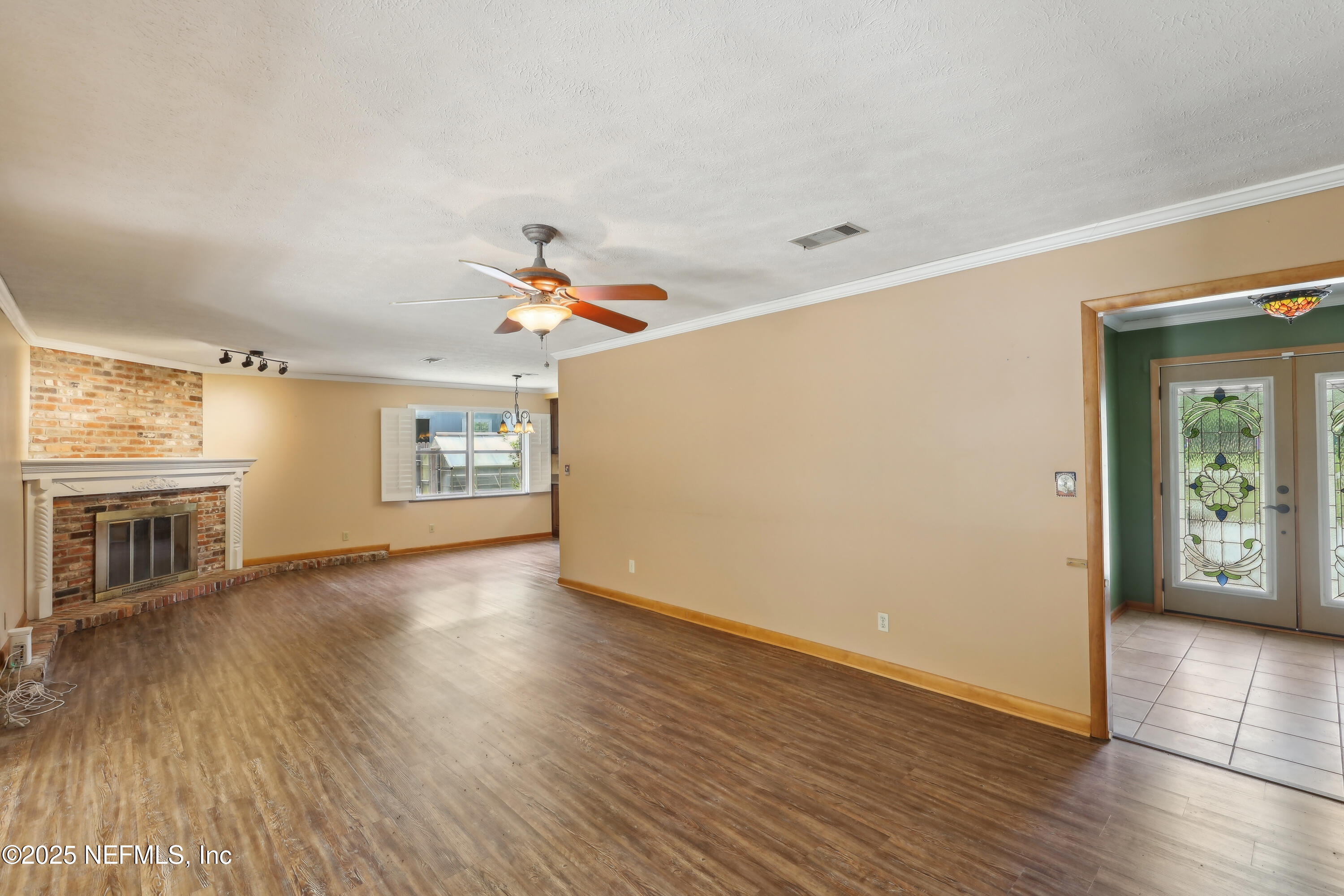 1071 Orangewood Road St. Johns, FL 32259 - Photo 12 of 56 a view of a livingroom with wooden floor and a ceiling fan