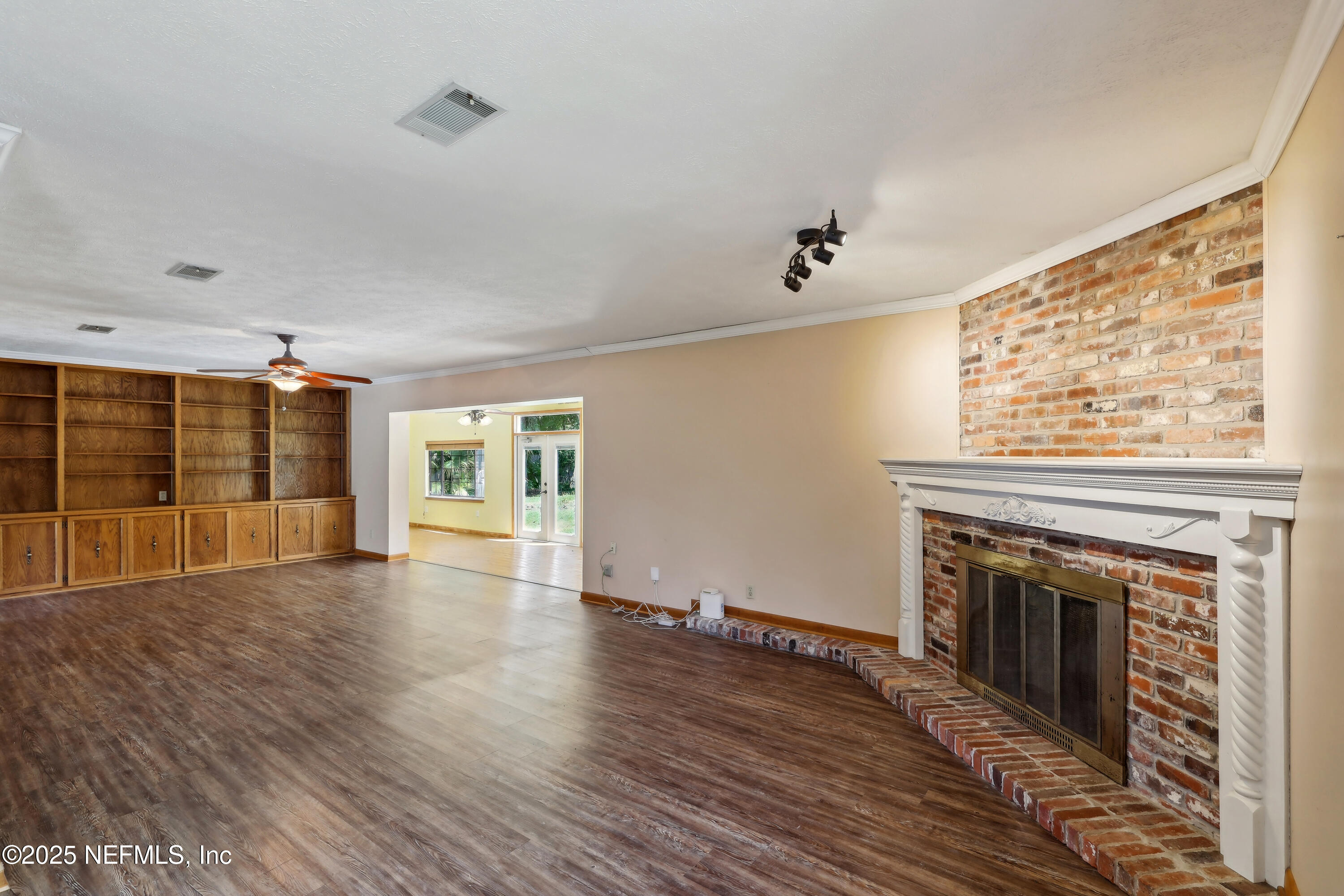 1071 Orangewood Road St. Johns, FL 32259 - Photo 15 of 56 wooden floor fireplace and windows in an empty room