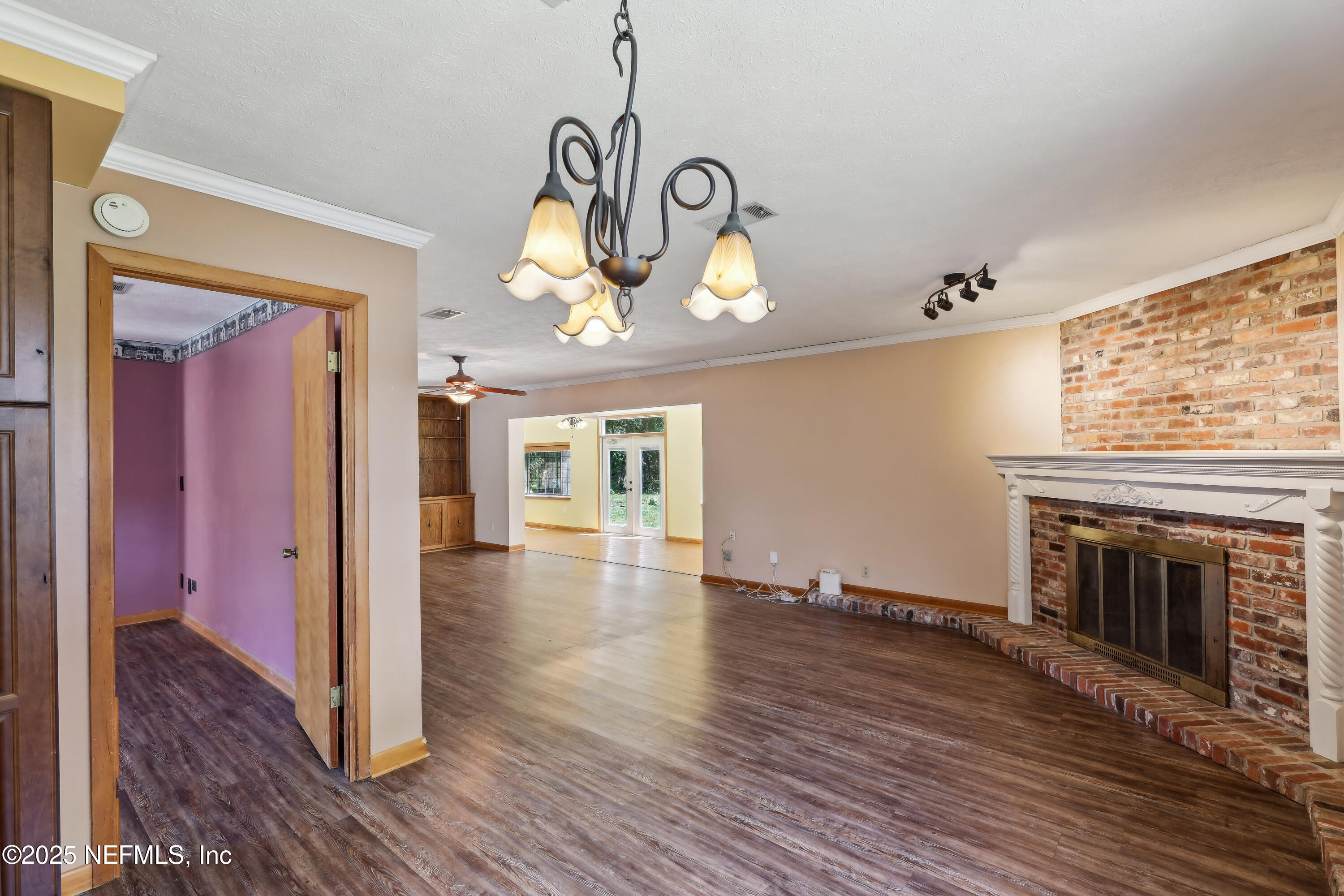 1071 Orangewood Road St. Johns, FL 32259 - Photo 17 of 56 a view of a livingroom with wooden floor a fireplace and window