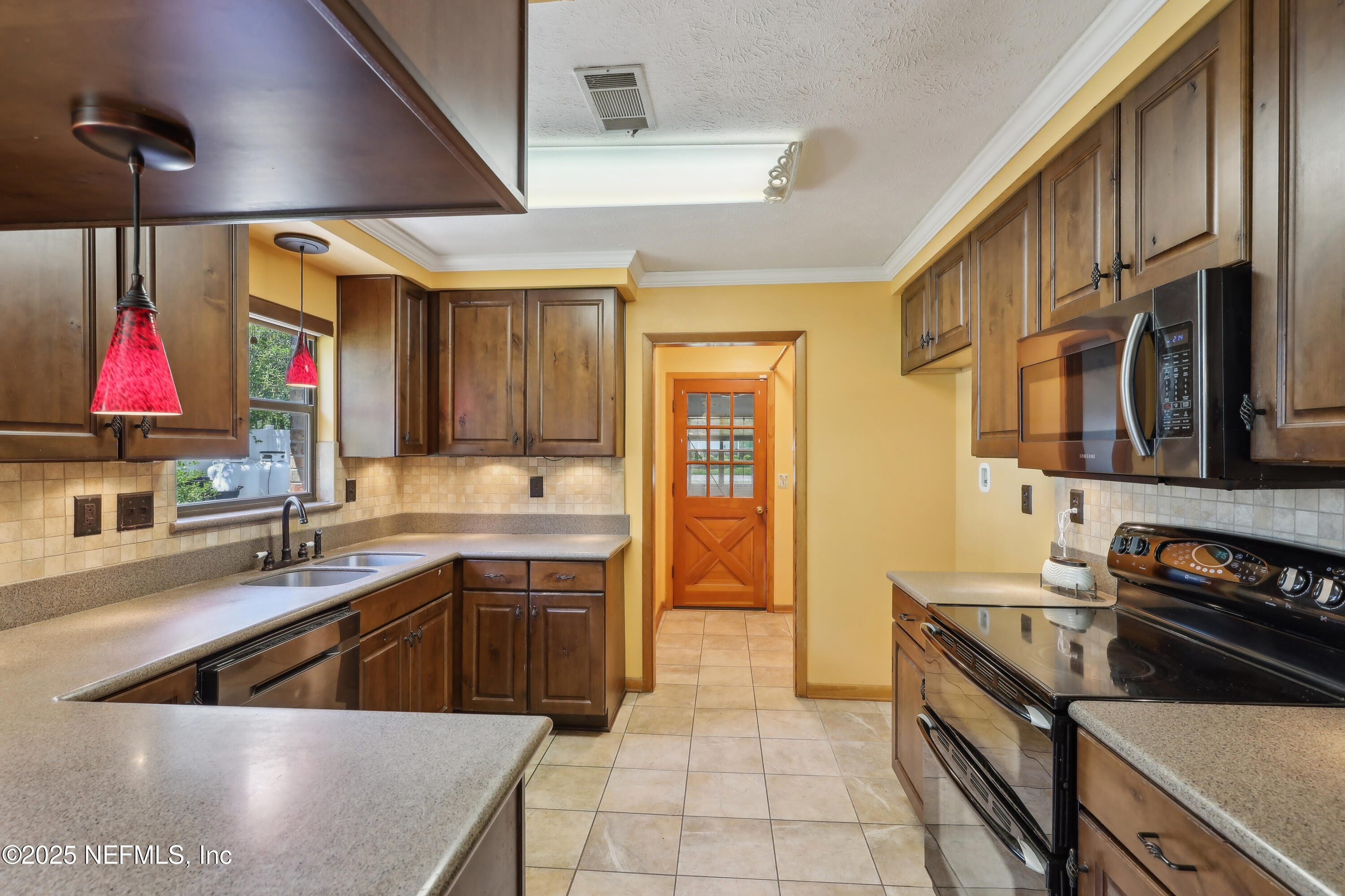 1071 Orangewood Road St. Johns, FL 32259 - Photo 19 of 56 a kitchen that has a lot of cabinets in it
