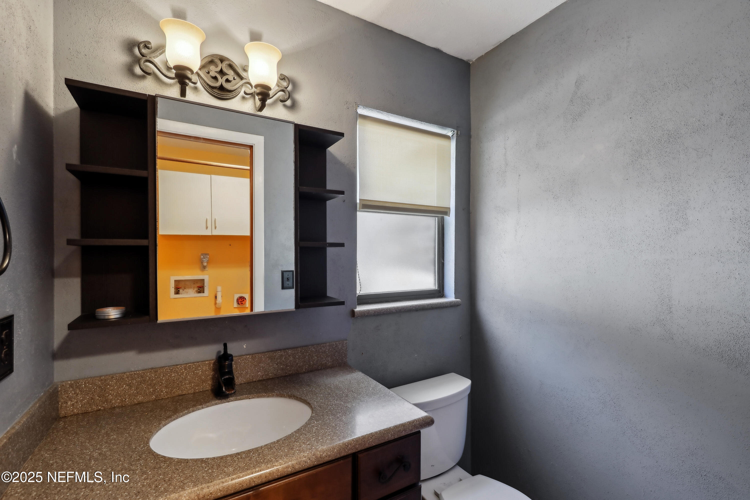 1071 Orangewood Road St. Johns, FL 32259 - Photo 23 of 56 a bathroom with a sink and a mirror