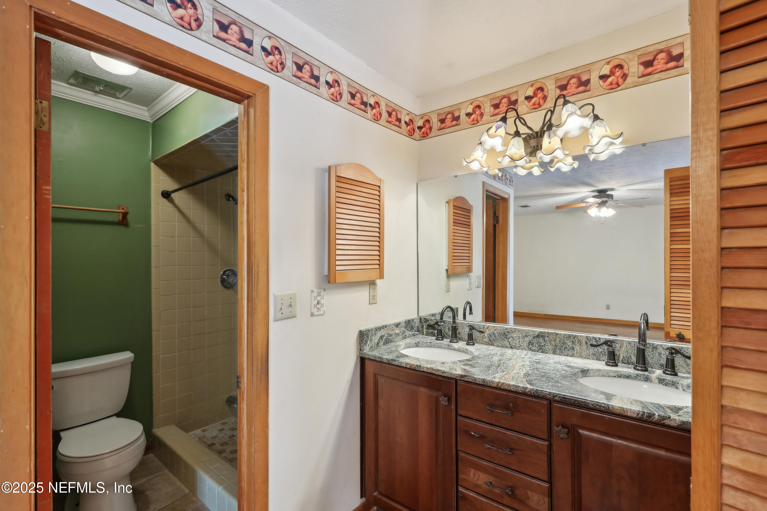 1071 Orangewood Road St. Johns, FL 32259 - Photo 33 of 56 a bathroom with a granite countertop sink a toilet and a mirror