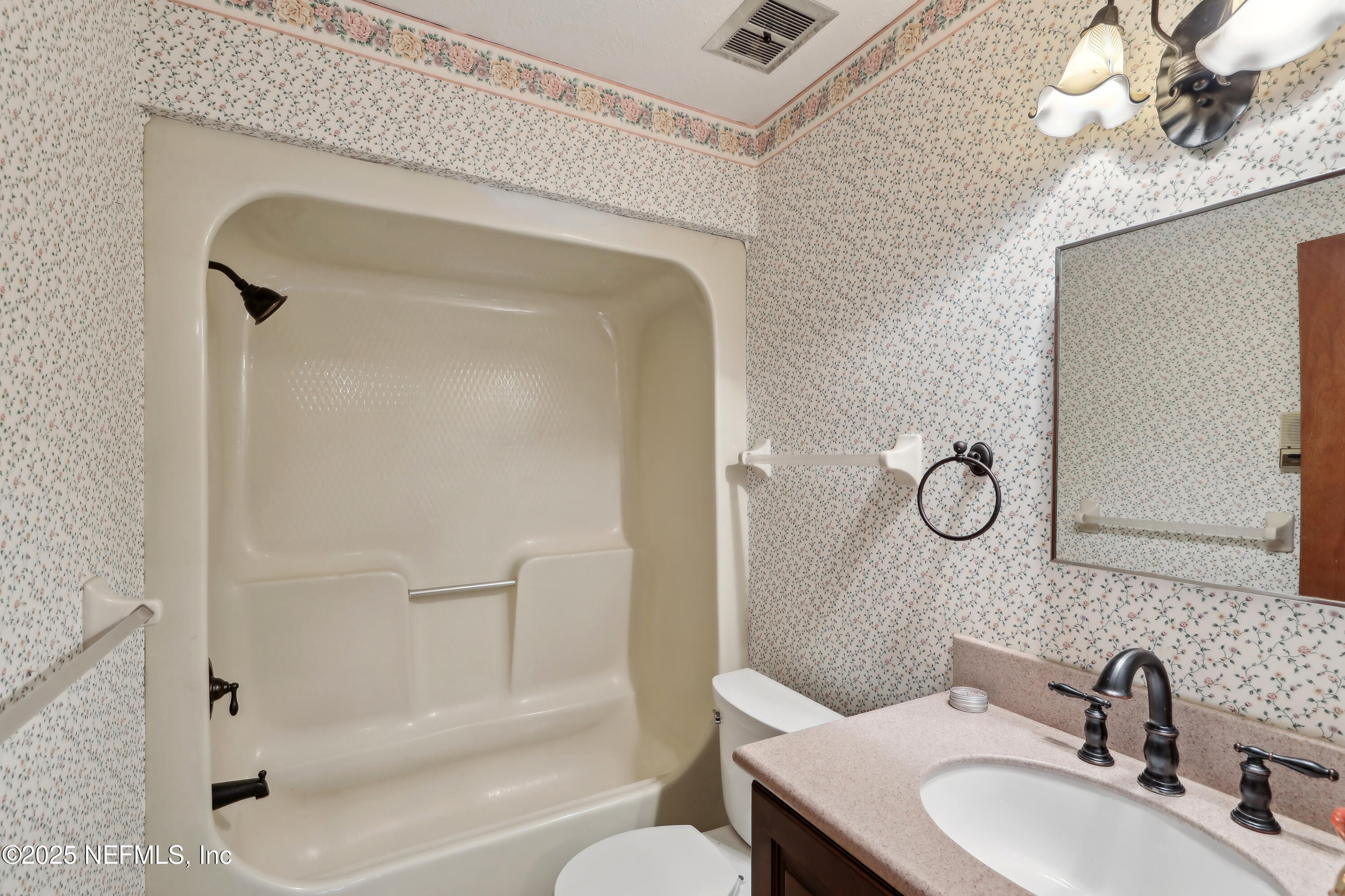1071 Orangewood Road St. Johns, FL 32259 - Photo 36 of 56 a bathroom with a granite countertop sink toilet and shower