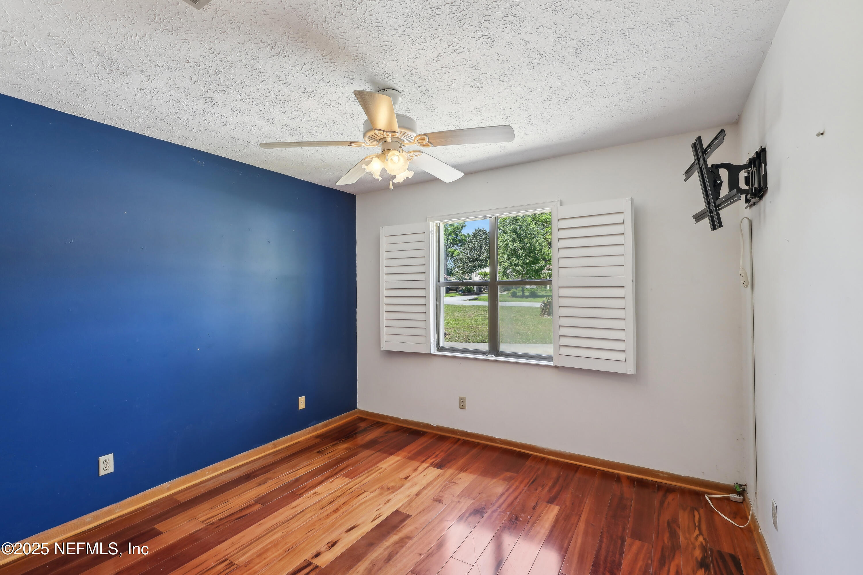 1071 Orangewood Road St. Johns, FL 32259 - Photo 37 of 56 an empty room with a window and a ceiling fan