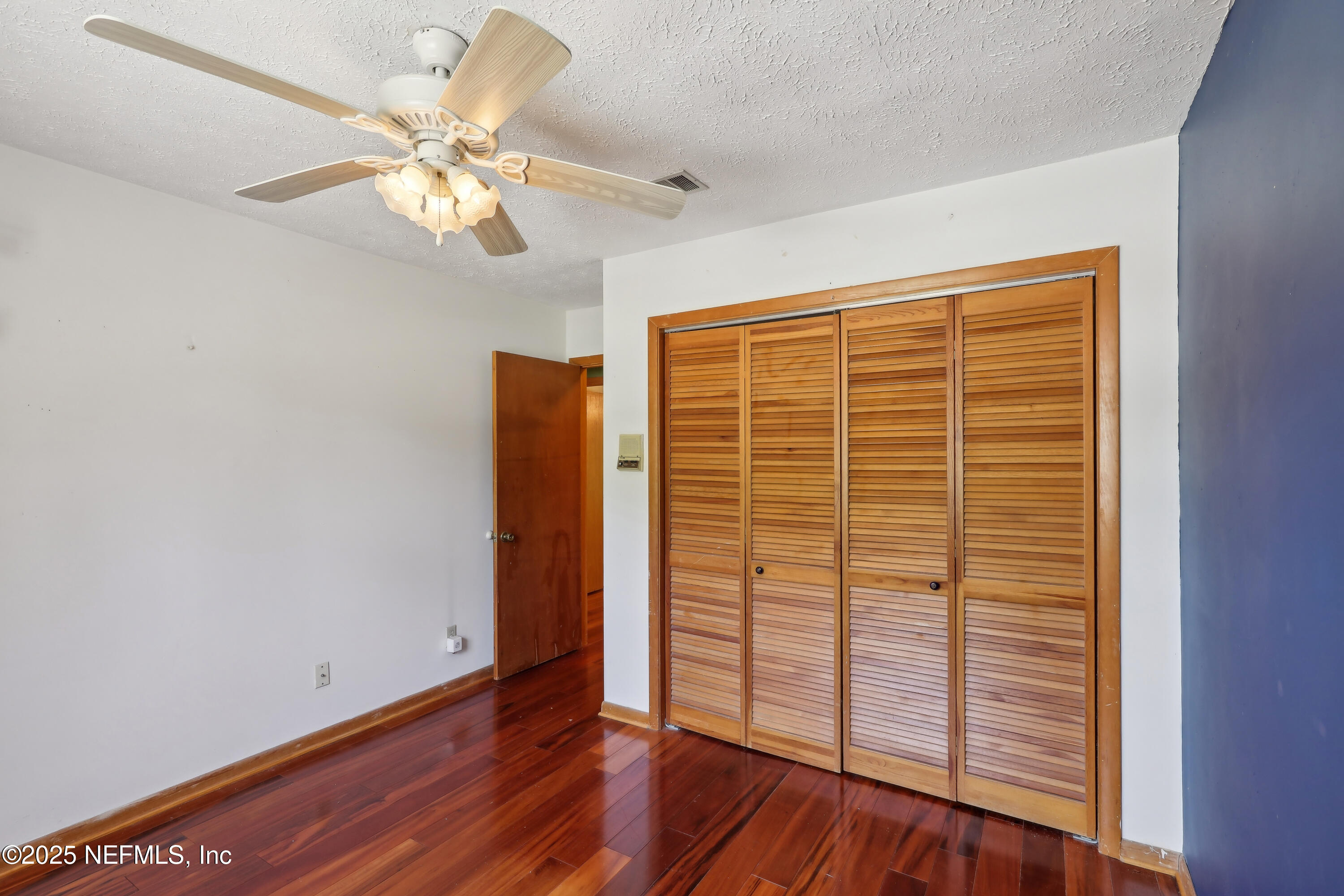 1071 Orangewood Road St. Johns, FL 32259 - Photo 38 of 56 an empty room with wooden floor fan and windows