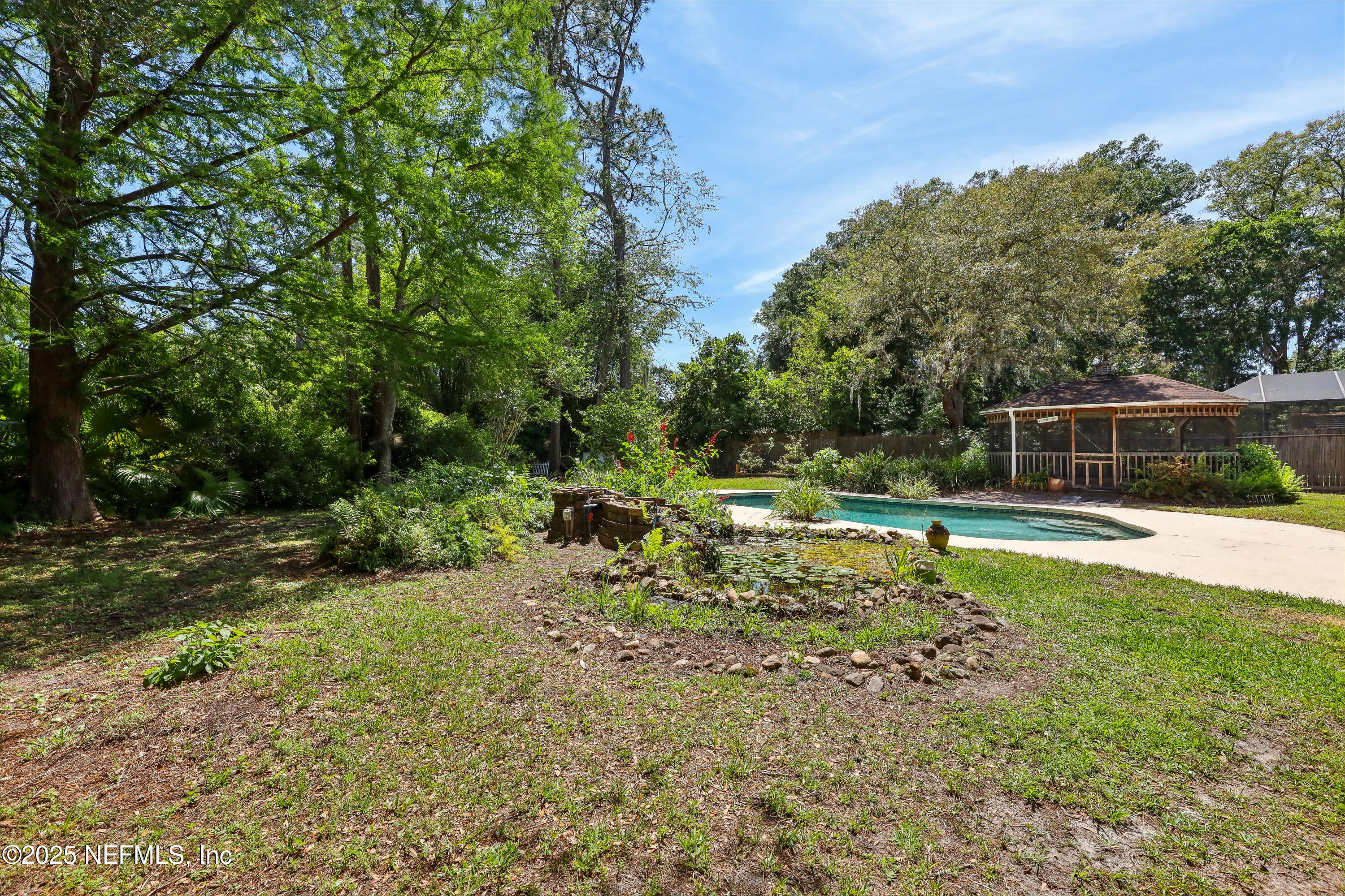 1071 Orangewood Road St. Johns, FL 32259 - Photo 40 of 56 a view of backyard with a small swimming pool and sitting area