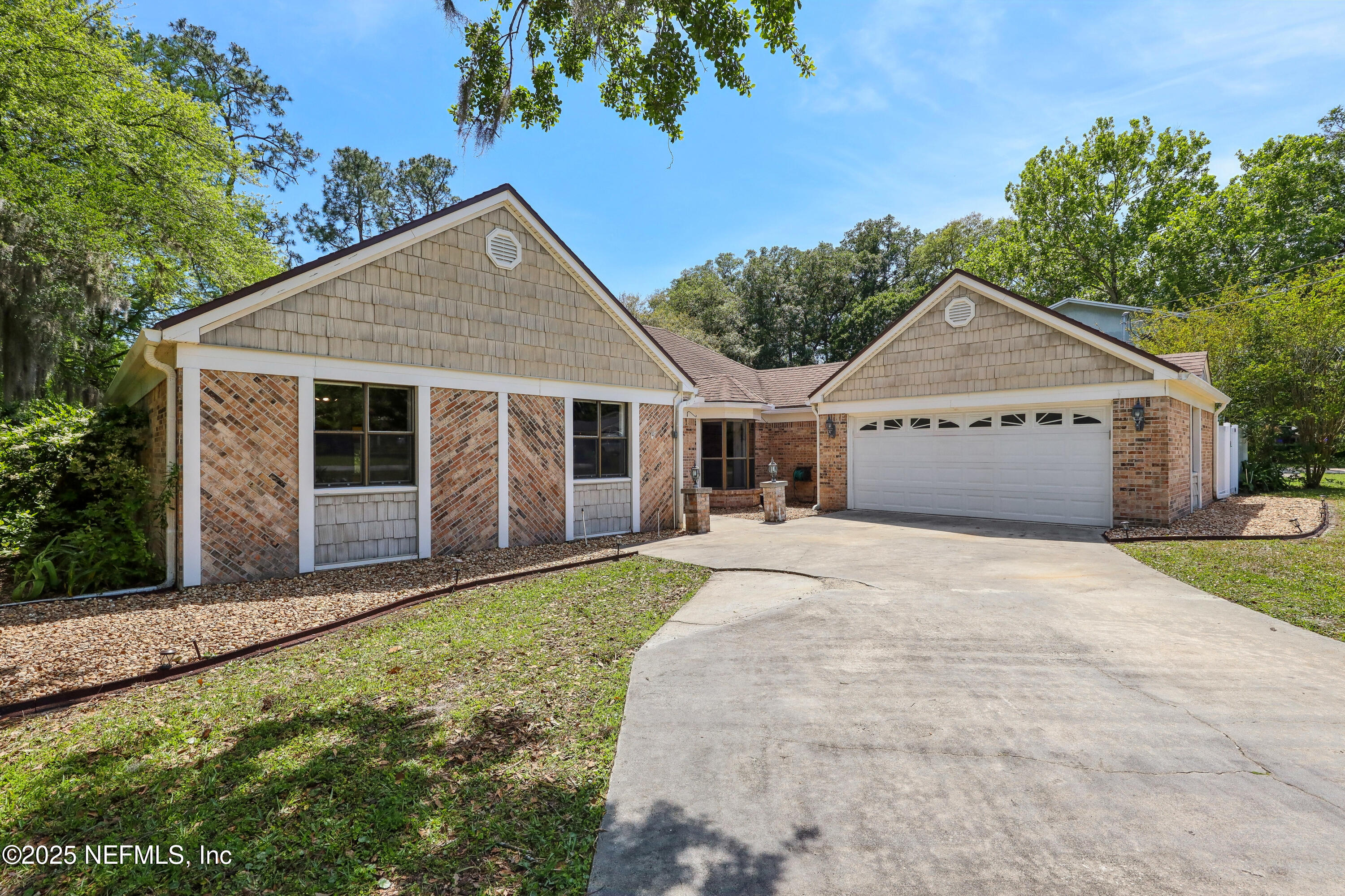 1071 Orangewood Road St. Johns, FL 32259 - Photo 5 of 56 a front view of a house with a garden and yard