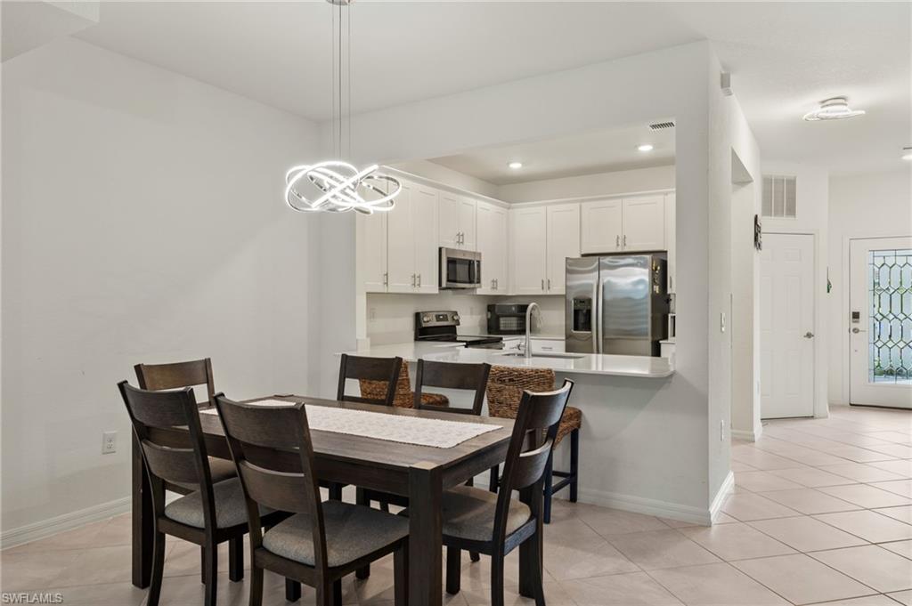 2934 Citrus Street Naples, FL 34120 - Photo 3 of 29 a view of a dining room and kitchen with a table chairs