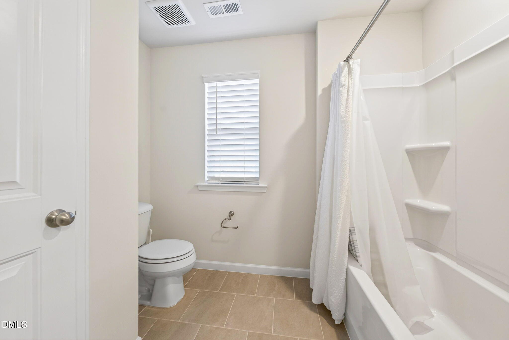 211 Kineton Woods Way Garner, NC 27529 - Photo 16 of 18 a bathroom with a toilet and a bathtub
