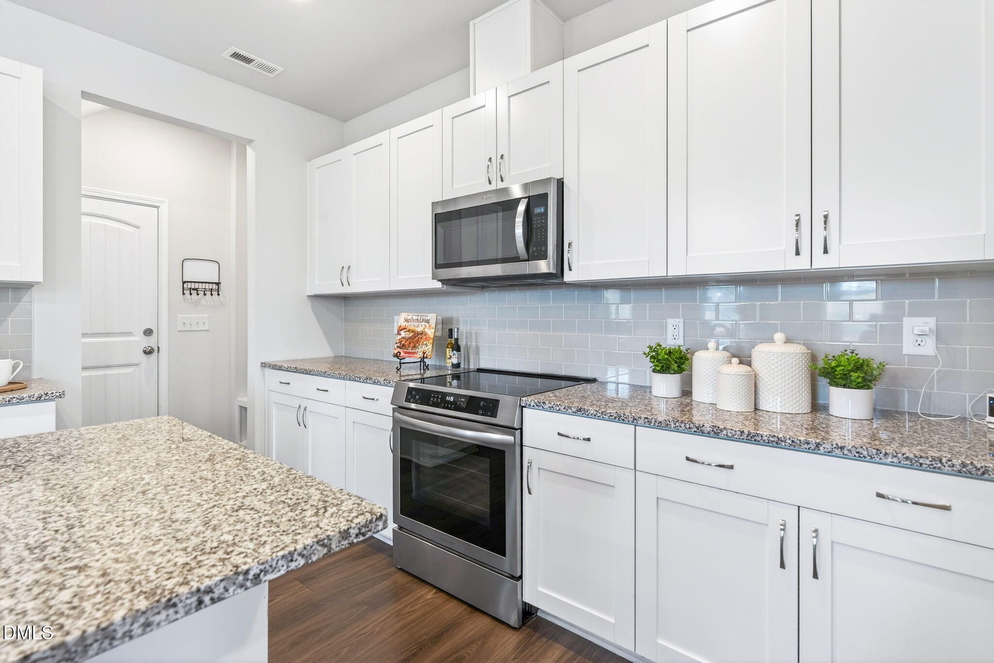 211 Kineton Woods Way Garner, NC 27529 - Photo 6 of 18 a kitchen with stainless steel appliances granite countertop a sink a stove and a granite counter tops