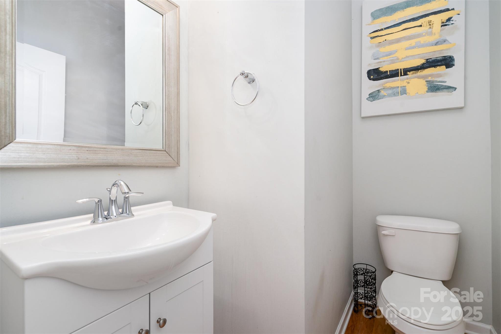 8931 Happiness Road Harrisburg, NC 28075 - Photo 11 of 32 a bathroom with a toilet sink and mirror