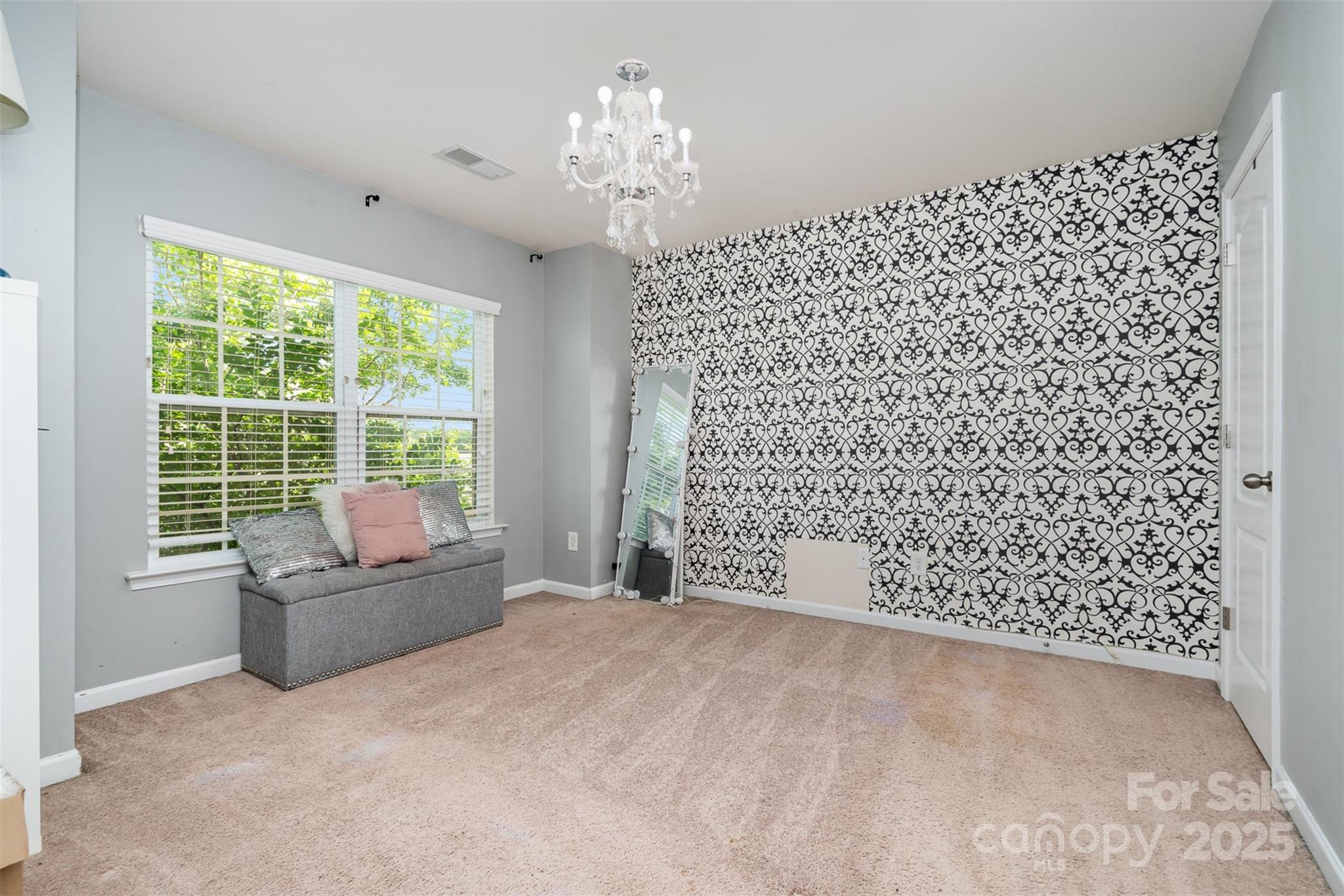 8931 Happiness Road Harrisburg, NC 28075 - Photo 18 of 32 a living room with a couch and a large window
