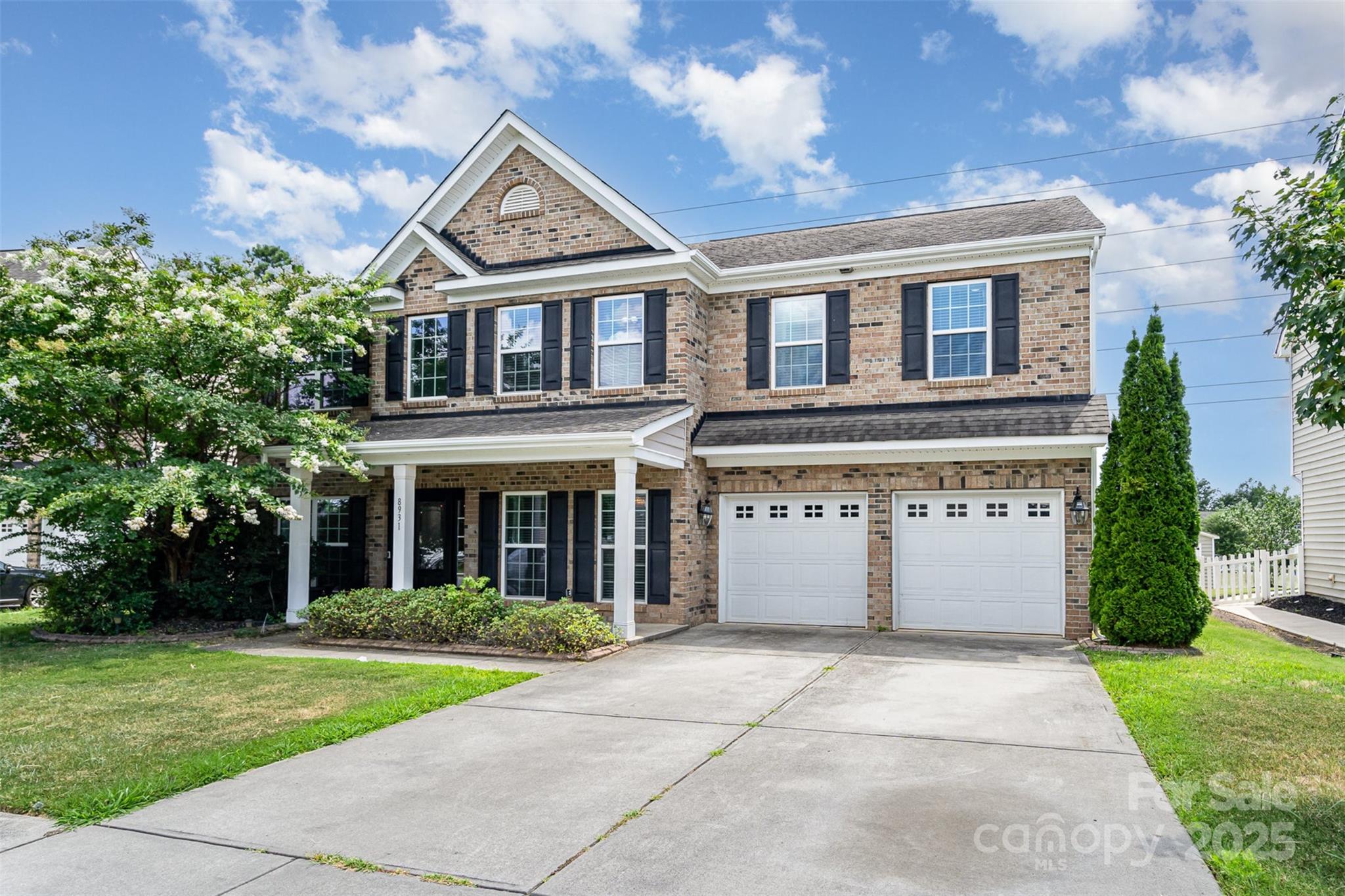 8931 Happiness Road Harrisburg, NC 28075 - Photo 2 of 32 a front view of a house with garden