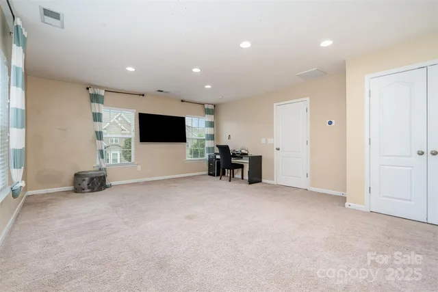 an empty room with furniture and white walls