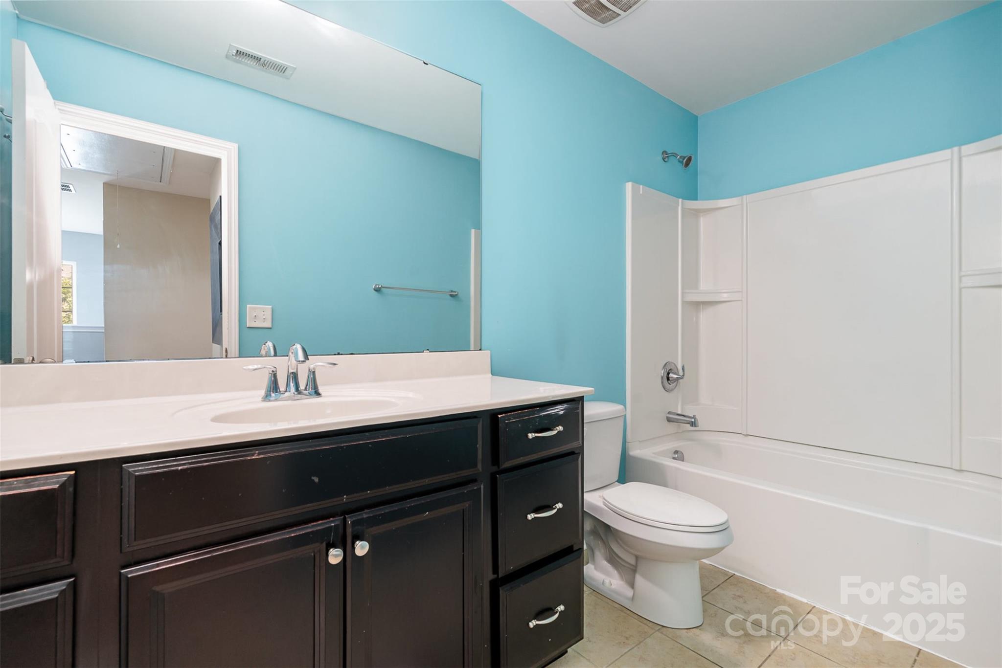 8931 Happiness Road Harrisburg, NC 28075 - Photo 22 of 32 a bathroom with a sink a toilet and shower