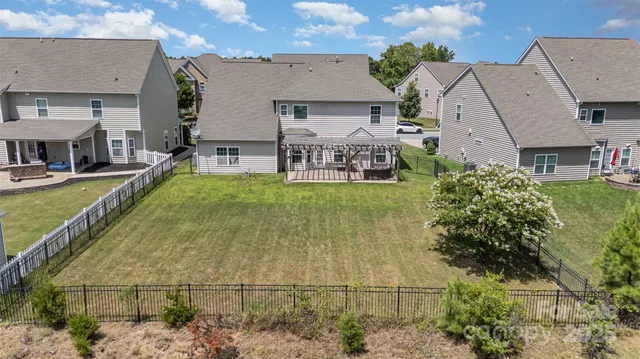 an aerial view of residential houses with outdoor space and swimming pool