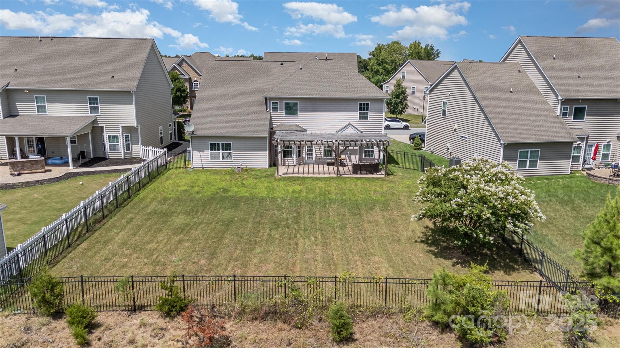 8931 Happiness Road Harrisburg, NC 28075 - Photo 25 of 32 an aerial view of residential houses with outdoor space and swimming pool