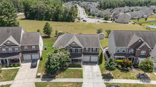 an aerial view of a house with garden space and lake view