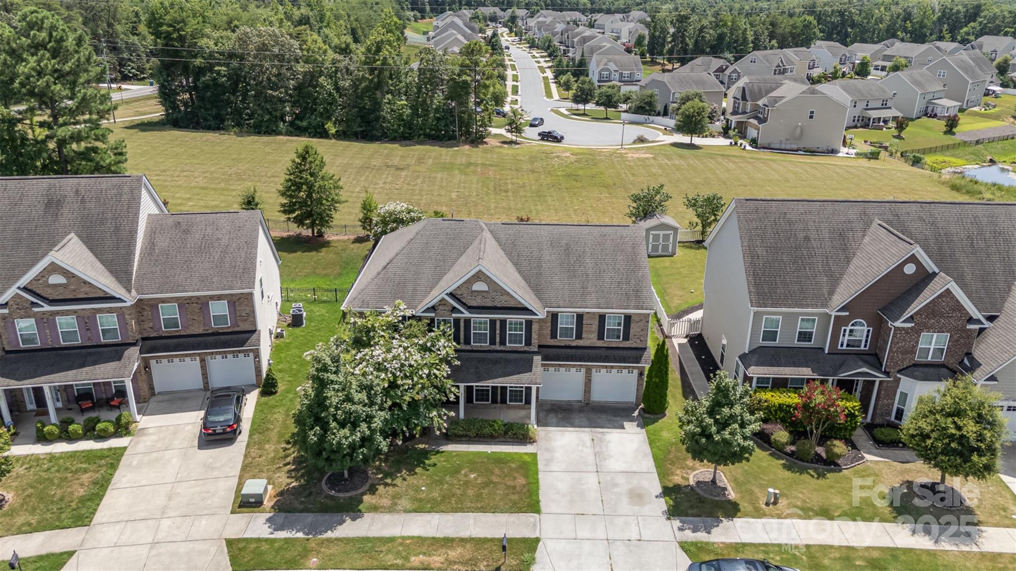 8931 Happiness Road Harrisburg, NC 28075 - Photo 26 of 32 an aerial view of a house with garden space and lake view