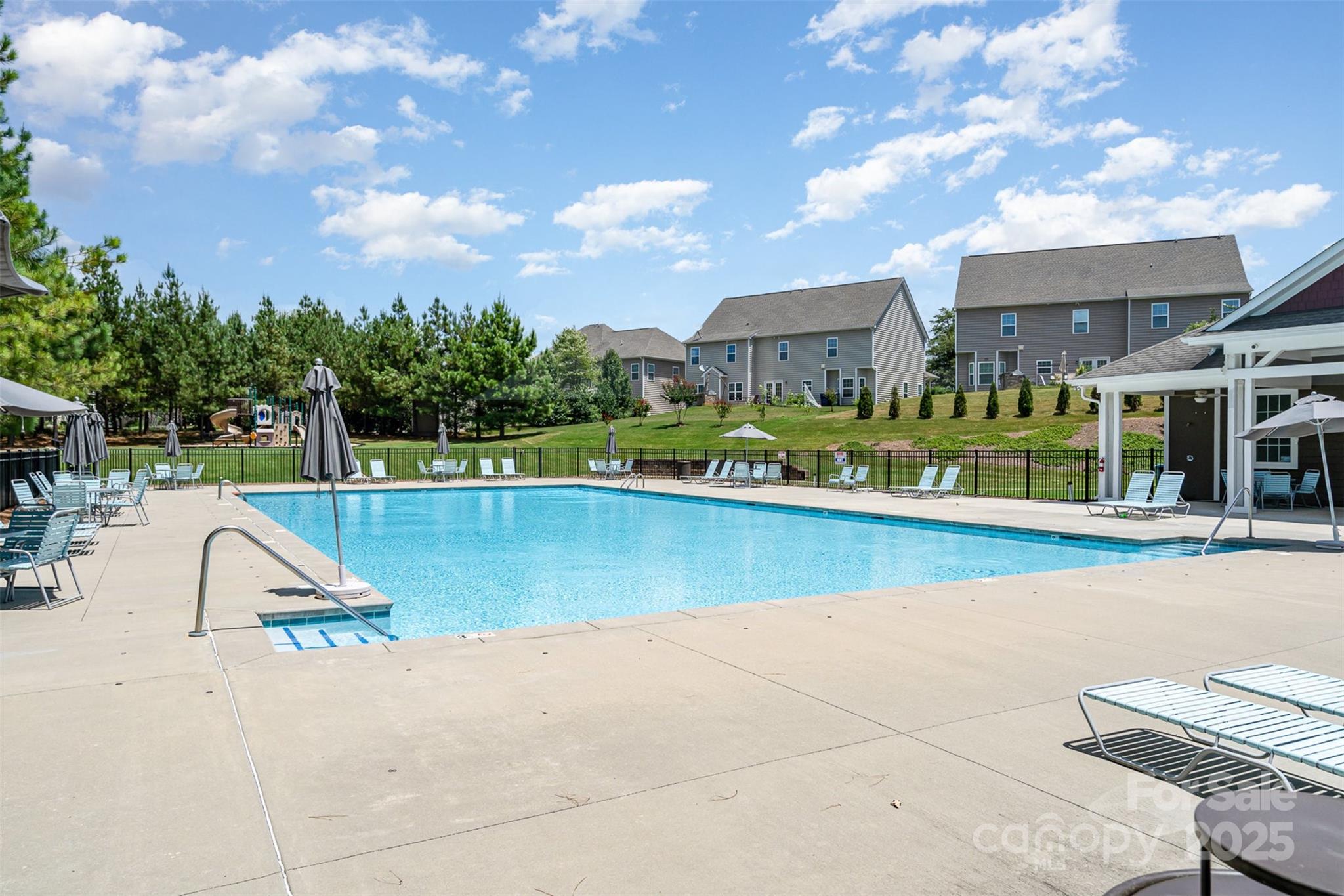 8931 Happiness Road Harrisburg, NC 28075 - Photo 27 of 32 a view of a swimming pool with a lounge chair