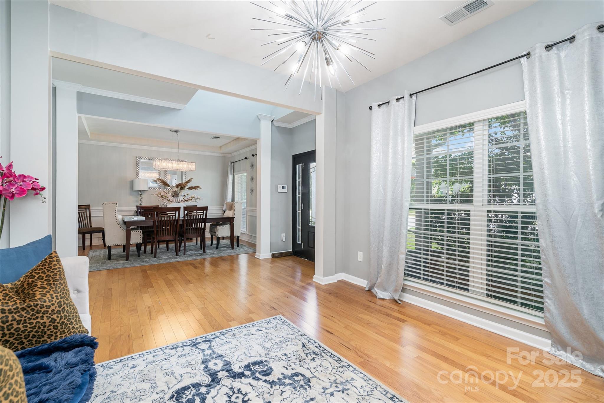 8931 Happiness Road Harrisburg, NC 28075 - Photo 3 of 32 a living room with furniture and a large window