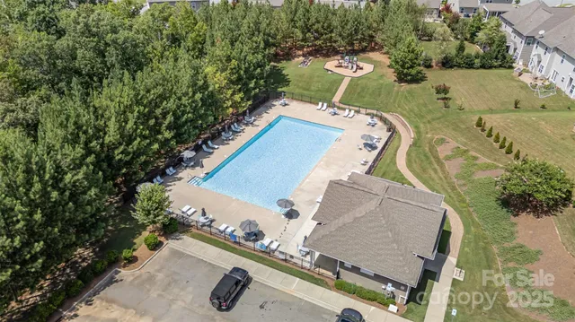 an aerial view of a house with a yard and trees