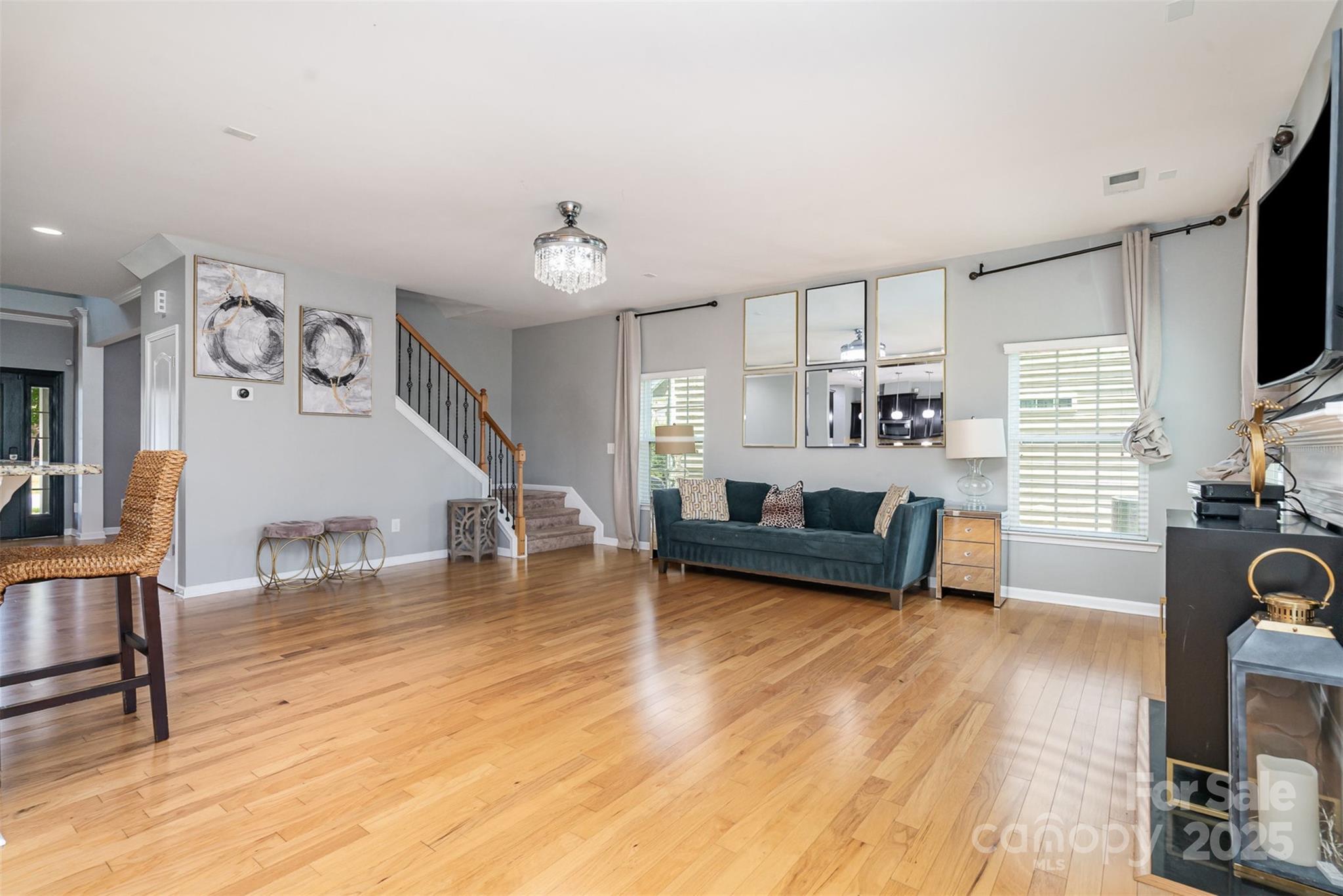 8931 Happiness Road Harrisburg, NC 28075 - Photo 5 of 32 a living room with furniture and a wooden floor