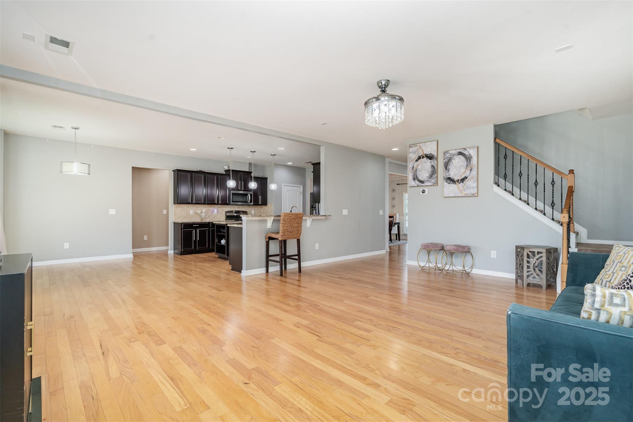 8931 Happiness Road Harrisburg, NC 28075 - Photo 6 of 32 a living room with furniture and kitchen view