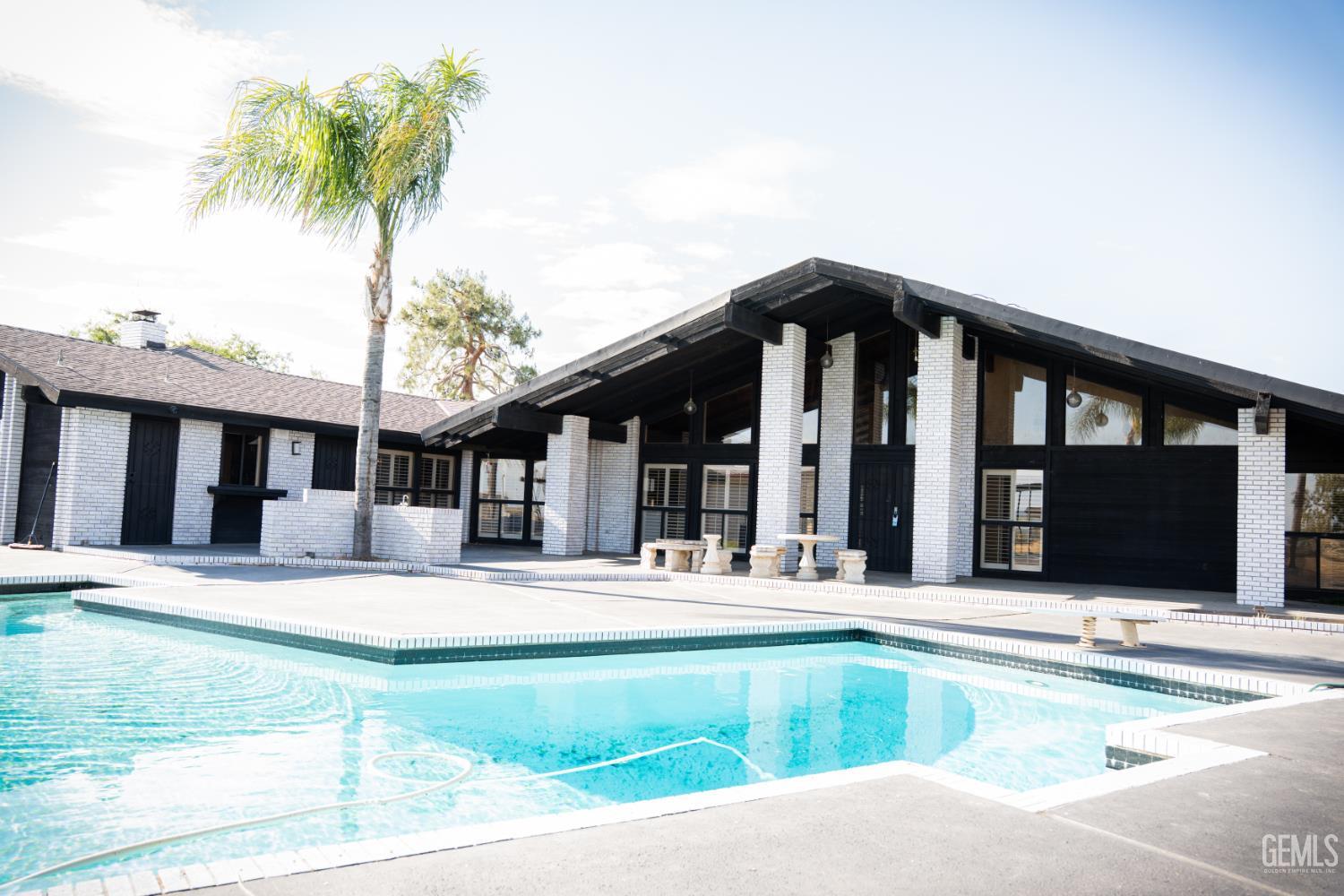 Undisclosed Address Bakersfield, CA 93308 - Photo 28 of 29 a view of a house with a swimming pool and a chair