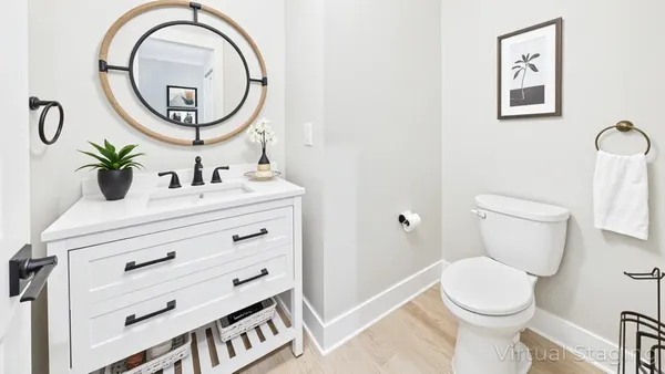 a bathroom with a toilet a sink and a mirror