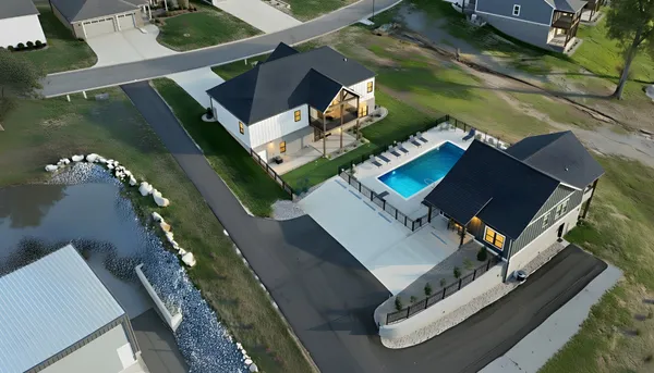 a view of a house with swimming pool and porch with furniture