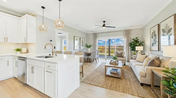 a living room with furniture a chandelier a sink and a window