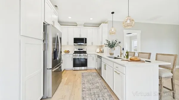 a kitchen with a sink a counter top space stainless steel appliances and cabinets