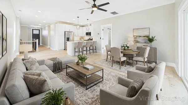 a living room with furniture kitchen view and a chandelier