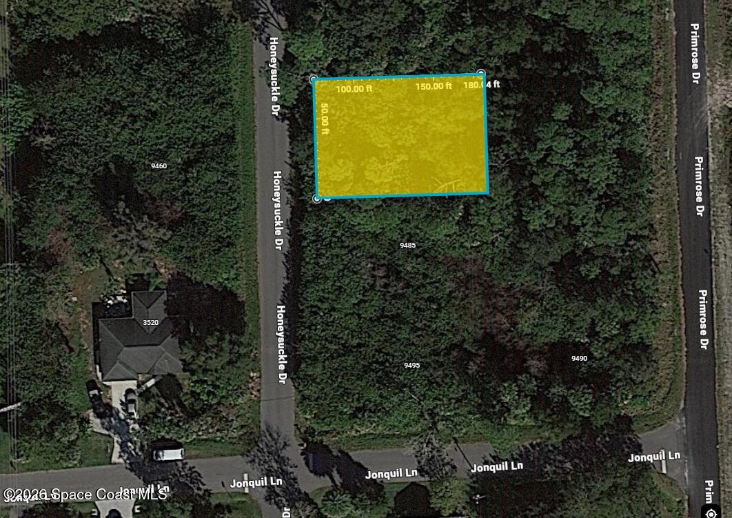 9475 Honeysuckle Drive Sebastian, FL 32976 - Photo 1 of 3 a view of a swimming pool and trees in the background