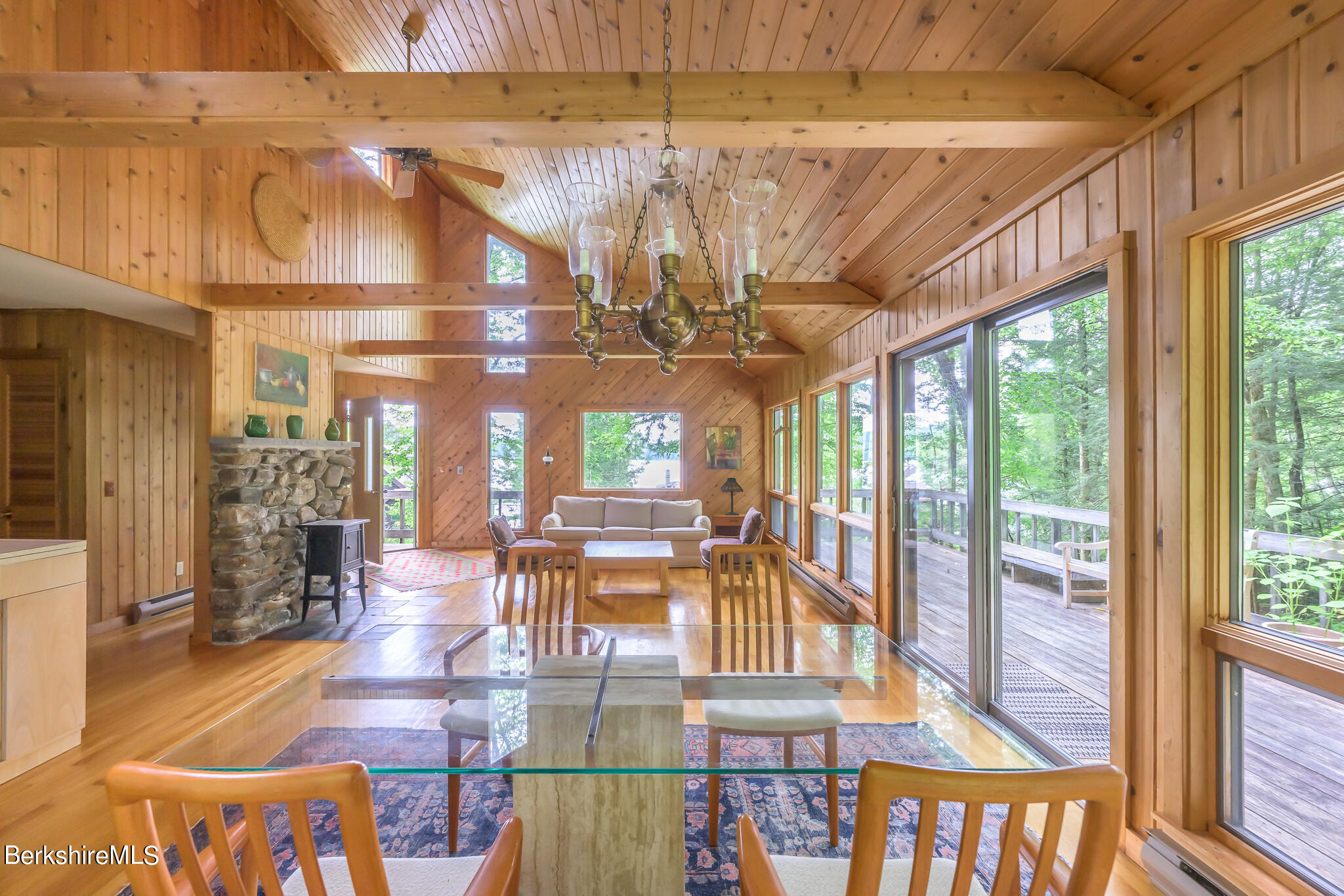 29 Lakeside Drive Tyringham, MA 01238 - Photo 11 of 31 a view of a dining area with furniture wooden floor and a chandelier
