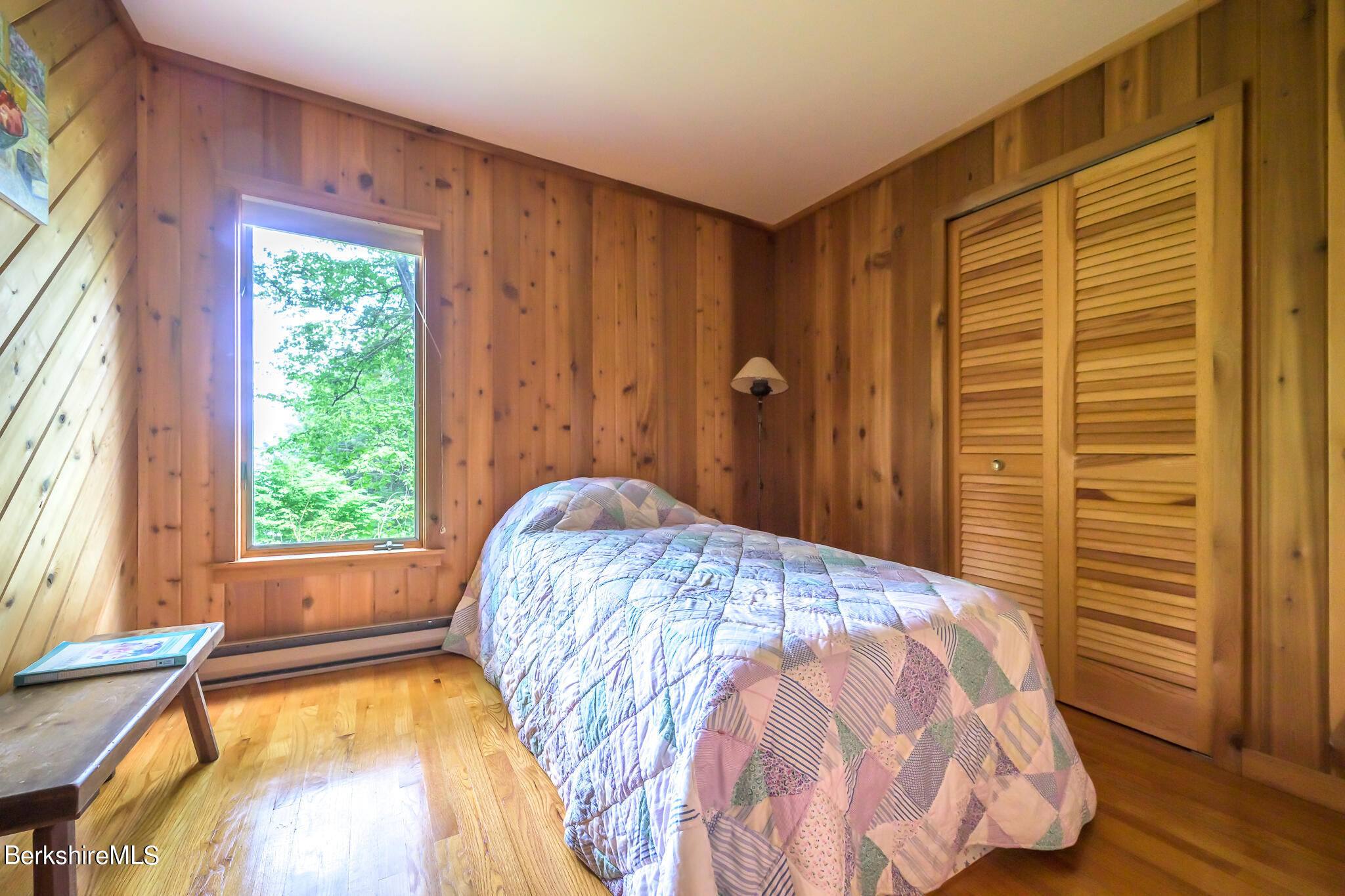 29 Lakeside Drive Tyringham, MA 01238 - Photo 17 of 31 a bed sitting in a bedroom next to a window