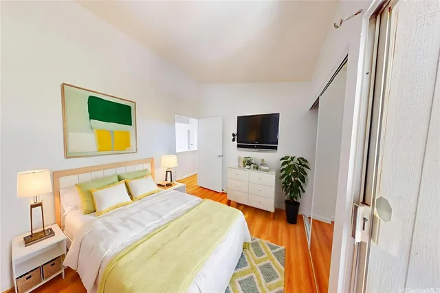 a bedroom with a bed and a television