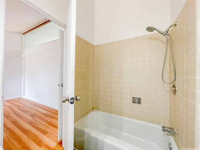 a bathroom with a bathtub and a shower