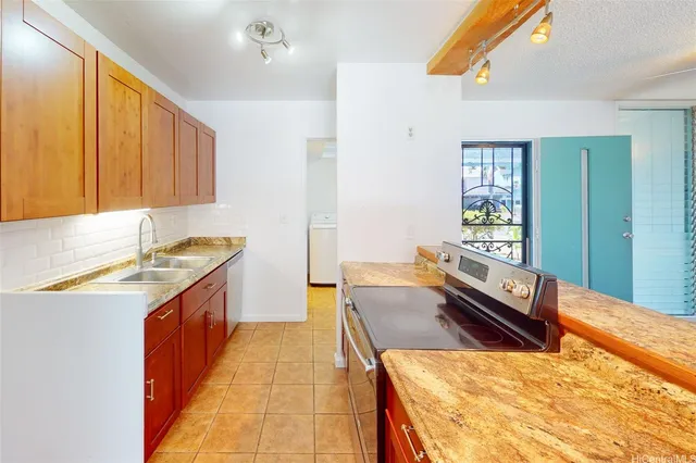 a kitchen with a stove a sink and a refrigerator