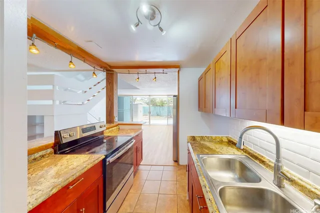 a kitchen with granite countertop a sink and a counter top space