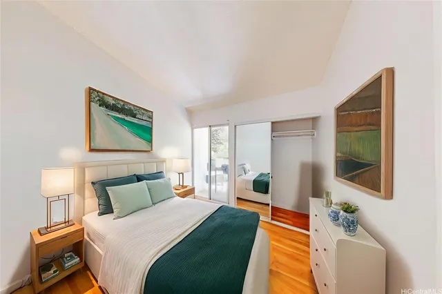 a bedroom with a bed and wooden floor