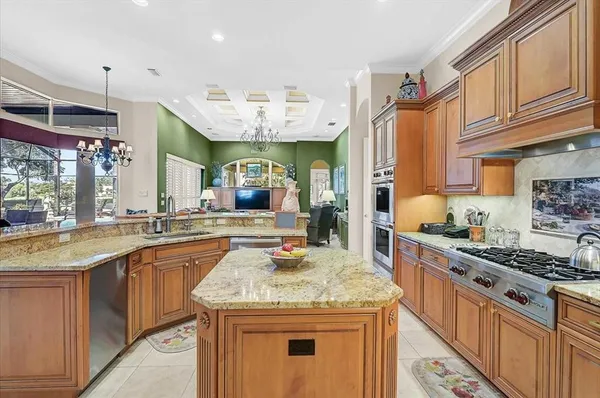 a living room with furniture chandelier and a large window