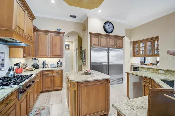 a living room with fireplace furniture and a chandelier