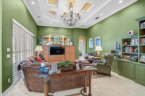 a bedroom with a bed a dresser and flat screen tv
