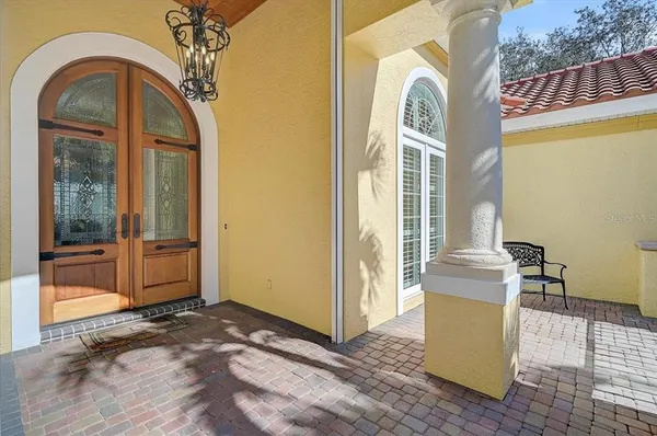 a room with lots of wooden furniture and windows