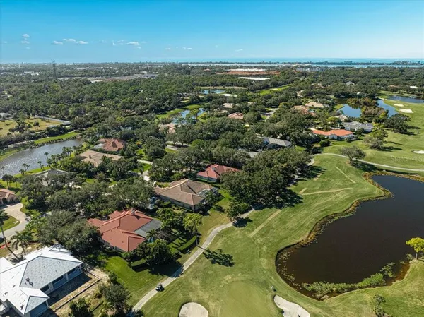 a view of a house with swimming pool and a yard