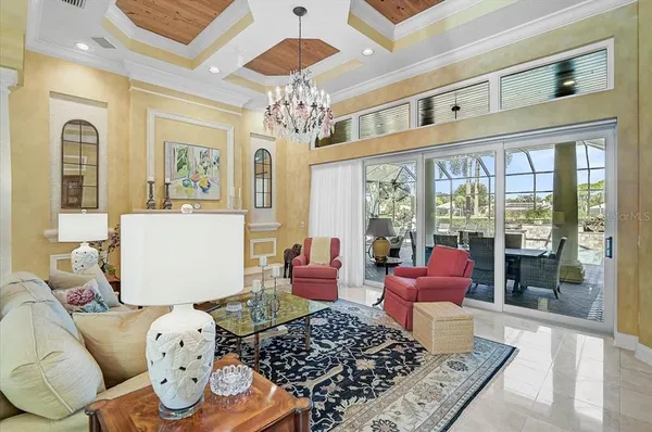 a dining room with furniture a chandelier and wooden floor